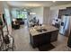 Open-concept kitchen with center island, stainless appliances, and view into the living room and dining area at 3371 Yellowtop Loop, Clermont, FL 34714