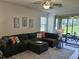 Comfortable living room featuring a large sectional sofa, ceiling fan, and sliding glass doors to the outdoor patio at 3371 Yellowtop Loop, Clermont, FL 34714