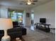 Open concept living room showcasing the furniture, neutral colors, ceiling fan, and sliding glass doors to the patio at 3371 Yellowtop Loop, Clermont, FL 34714