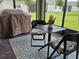 Relaxing screened patio area with seating, grill, and view of the landscaped backyard at 3371 Yellowtop Loop, Clermont, FL 34714