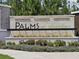 Community sign featuring the name 'Palms at Serenoa', set against a backdrop of lush landscaping at 3371 Yellowtop Loop, Clermont, FL 34714