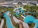 Aerial view of community waterpark featuring lazy river, slides, pools, and lush landscaping at 3715 Lana Ave, Davenport, FL 33897