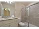 Bathroom featuring a granite countertop, white cabinets, toilet, and glass-enclosed shower at 3715 Lana Ave, Davenport, FL 33897