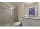 Bathroom featuring a granite countertop, white cabinets, toilet, and glass-enclosed shower at 3715 Lana Ave, Davenport, FL 33897