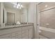Bathroom features double sinks, white cabinets, granite countertop, and a bathtub at 3715 Lana Ave, Davenport, FL 33897