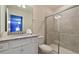 Bathroom featuring a granite countertop, white cabinets, toilet, and glass-enclosed shower at 3715 Lana Ave, Davenport, FL 33897