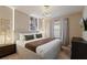 Serene bedroom featuring a queen-sized bed, stylish wall decor, and soft neutral tones at 3715 Lana Ave, Davenport, FL 33897