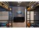 Themed bedroom features four bunk beds, a dresser, and a flat-screen television at 3715 Lana Ave, Davenport, FL 33897