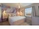 Bright bedroom featuring a large bed, flamingo accent wall, and a window for natural light at 3715 Lana Ave, Davenport, FL 33897