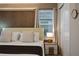 Modern bedroom featuring large bed, accent wall, and large window at 3715 Lana Ave, Davenport, FL 33897