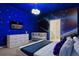 A themed bedroom showcases space-themed wall art, a modern bed, and stylish lighting fixtures at 3715 Lana Ave, Davenport, FL 33897