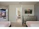 Cozy bedroom showcasing a neutral color scheme, decorative television, and access to an adjacent room at 3715 Lana Ave, Davenport, FL 33897