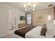 Bright bedroom showcasing a king bed, stylish decor, and a connecting bathroom at 3715 Lana Ave, Davenport, FL 33897