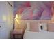 Charming bedroom featuring a flamingo accent wall, plush bed, and unique origami bird lighting at 3715 Lana Ave, Davenport, FL 33897