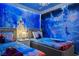 Themed bedroom featuring custom mural art, two twin beds, and unique snowflake lighting at 3715 Lana Ave, Davenport, FL 33897