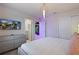 Modern bedroom with a grey dresser, plush bed, and access to an ensuite bathroom at 3715 Lana Ave, Davenport, FL 33897