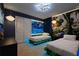 Whimsical bedroom featuring themed decor, twin beds with lit platform bases, and overhead lighting at 3715 Lana Ave, Davenport, FL 33897