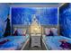 Whimsical themed bedroom with two twin beds, custom mural art, and unique snowflake lighting at 3715 Lana Ave, Davenport, FL 33897
