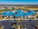 An aerial view of the community center showcasing its blue roof, parking lot, and surrounding residential area at 3715 Lana Ave, Davenport, FL 33897