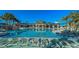 Expansive community pool with ample seating and umbrellas, set against a backdrop of manicured landscaping at 3715 Lana Ave, Davenport, FL 33897