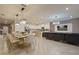 Bright dining area open to kitchen with pendant lights and a stainless steel refrigerator at 3715 Lana Ave, Davenport, FL 33897