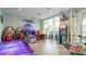 Bright game room with various arcade games and large windows for natural light at 3715 Lana Ave, Davenport, FL 33897