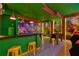 Mario-themed game room with bar seating, vibrant decor, and a foosball table for entertainment at 3715 Lana Ave, Davenport, FL 33897