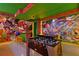 Gaming room with a bar and foosball table, adorned with vibrant Mario-themed decorations and colorful lights at 3715 Lana Ave, Davenport, FL 33897