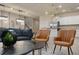 An open-concept living area boasts stylish seating and decor, connecting seamlessly to the kitchen and staircase at 3715 Lana Ave, Davenport, FL 33897
