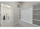 Well-organized mudroom with white built-in shelving, a coat rack, and neutral tiling at 3715 Lana Ave, Davenport, FL 33897