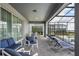 A screened in patio with two seating areas, a table and chairs, and a set of lounge chairs at 3715 Lana Ave, Davenport, FL 33897