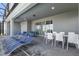 A screened in patio with two seating areas, a table and chairs, and a set of lounge chairs at 3715 Lana Ave, Davenport, FL 33897