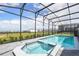 A screened in backyard pool and spa is surrounded by a brick patio at 3715 Lana Ave, Davenport, FL 33897