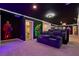 Spacious recreation room featuring superhero themed decorations, theater seating, and neon lighting at 3715 Lana Ave, Davenport, FL 33897