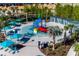 Aerial view of a colorful splash pad with lounge chairs and shaded cabanas for a relaxing day of fun at 3715 Lana Ave, Davenport, FL 33897