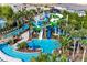 An aerial view of the waterpark featuring winding slides, a lazy river, and a pool surrounded by lush landscaping at 3715 Lana Ave, Davenport, FL 33897
