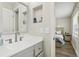 Bright bathroom featuring a white countertop, a sink with gray vanity, mirror, and an open doorway at 3816 Tram Ct, Orlando, FL 32810