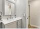 Bright bathroom featuring a white countertop, a sink with gray vanity, and a framed mirror at 3816 Tram Ct, Orlando, FL 32810