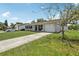 A single-story home with grey siding, a concrete driveway and an attached one car garage at 3816 Tram Ct, Orlando, FL 32810
