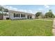 A single-story home with grey siding, dark shutters, a green lawn and an attached garage at 3816 Tram Ct, Orlando, FL 32810