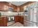 Kitchen showcasing rich wood cabinets, granite countertops and stainless steel appliances at 3816 Tram Ct, Orlando, FL 32810
