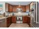 Well-equipped kitchen with rich wood cabinets, stainless steel appliances, and granite countertops at 3816 Tram Ct, Orlando, FL 32810