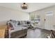 Living room with wood-look flooring, a white front door and a comfy sectional couch at 3816 Tram Ct, Orlando, FL 32810