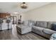 Inviting living room featuring wood-look flooring, a ceiling fan and a comfortable sectional couch at 3816 Tram Ct, Orlando, FL 32810