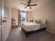 Inviting bedroom featuring a comfortable bed, soft carpet, and a bright window view at 391 Cape Honeysuckle Pl, Sanford, FL 32771