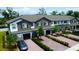 Beautiful townhouse exterior with brick driveways, manicured landscaping and attached garages at 391 Cape Honeysuckle Pl, Sanford, FL 32771