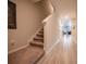 Bright hallway with wood-look tile flooring and carpeted stairs leading to the upper level at 391 Cape Honeysuckle Pl, Sanford, FL 32771