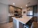 Well-appointed kitchen featuring a large island with seating, stainless steel appliances, and ample cabinet space at 391 Cape Honeysuckle Pl, Sanford, FL 32771