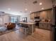 Open-concept kitchen and living area with modern appliances, island seating, and stylish décor at 391 Cape Honeysuckle Pl, Sanford, FL 32771