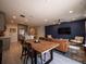 Open-concept living room and kitchen with modern decor and stainless steel appliances at 391 Cape Honeysuckle Pl, Sanford, FL 32771